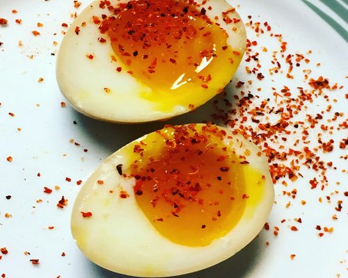 Soft boiled eggs served in a traditional kopitiam saucer with white pepper