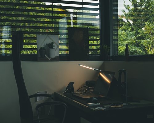 A dark dynamic layout of fresh clean water pitcher on a workplace desk